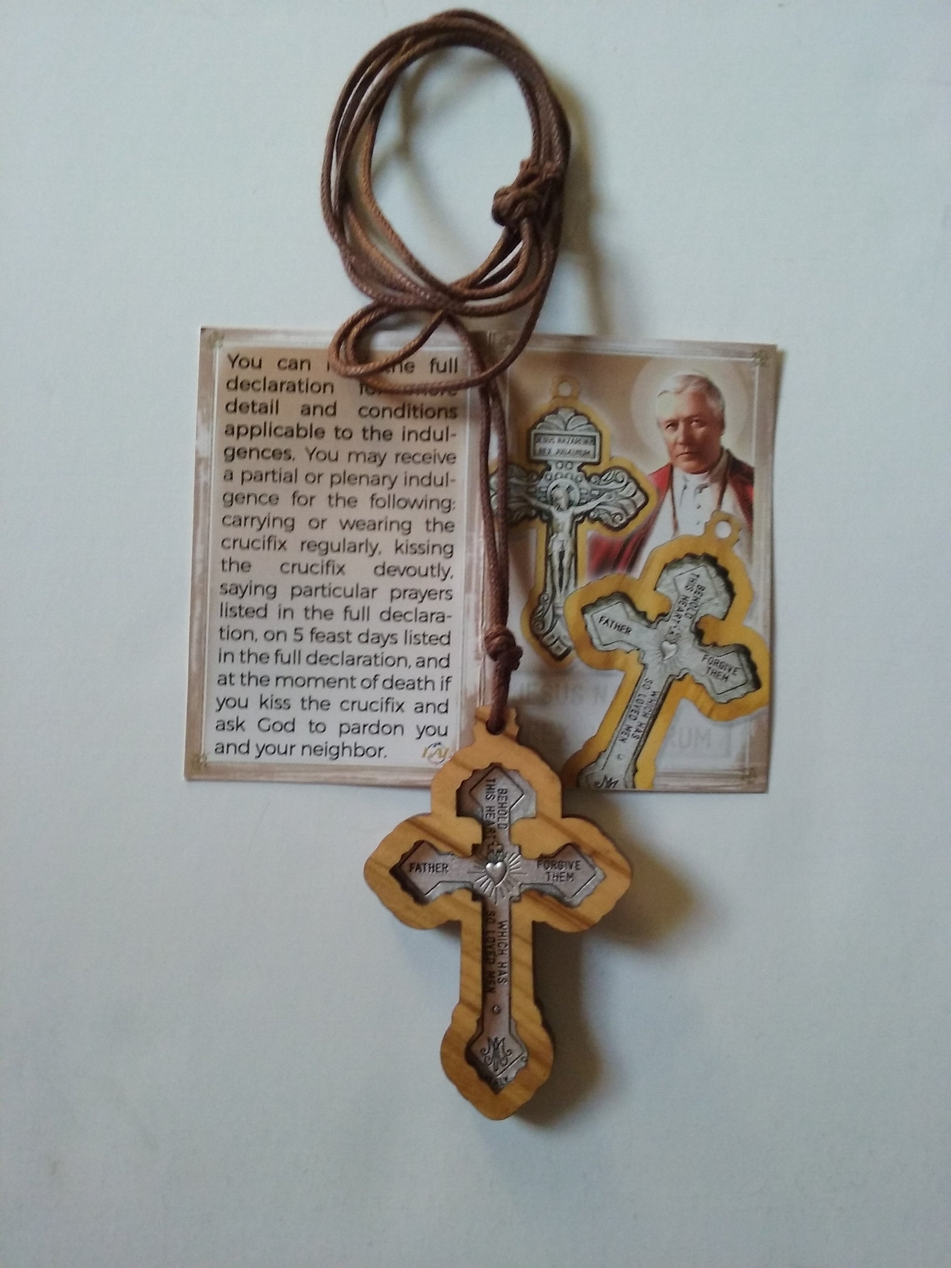 Picture of backside of Pardon Crucifix on brown cord and explanation card