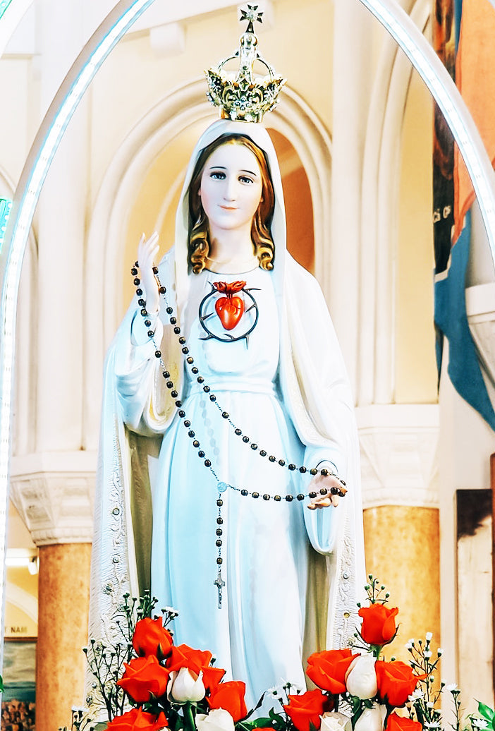 our lady with roses at her feet and rosary in her hands