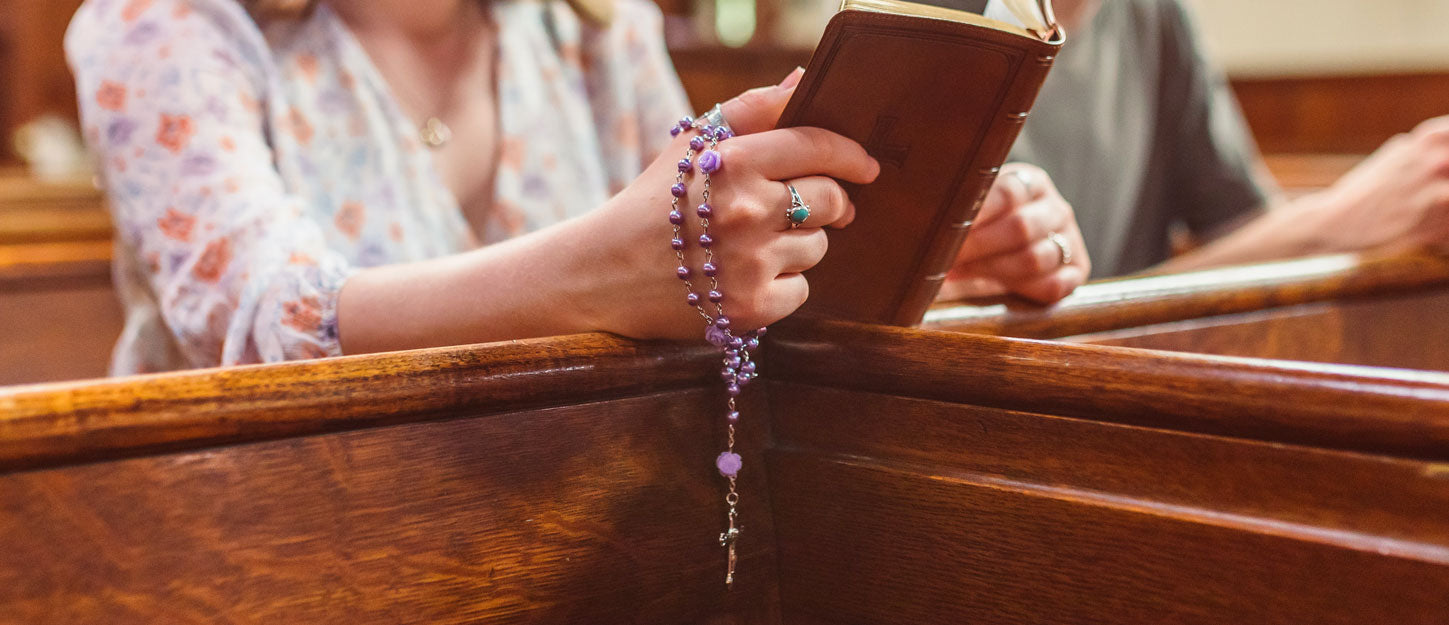 praying hands, woman saying the rosary, person kneeling in church