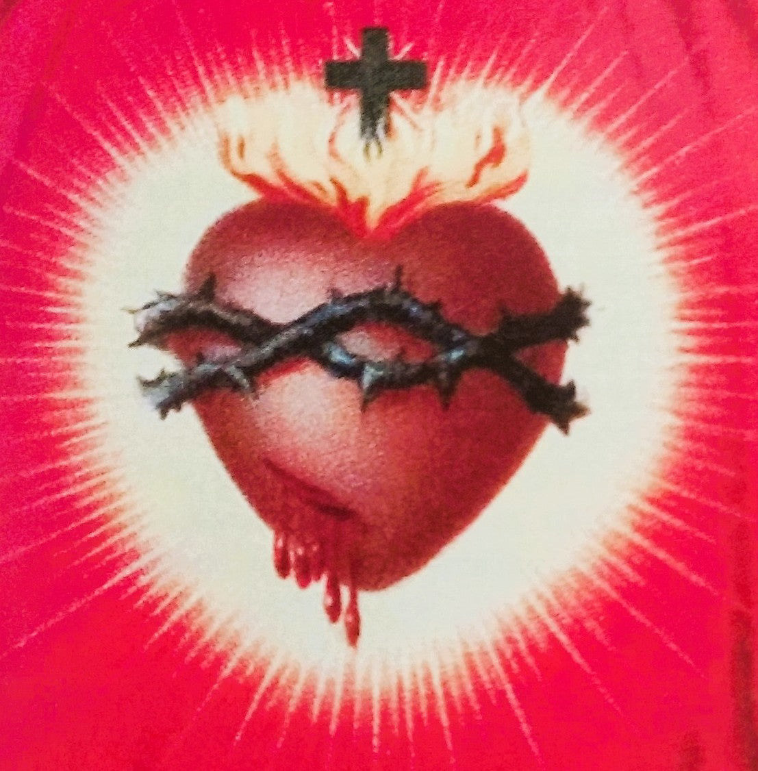 Heart with thorns and cross on a red background